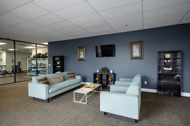 Light blue couches coffee table living room at Mountain Valley Apartments in Morgantown Student Accommodation