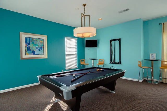 Pool table cues artwork bar stools and tables common area at Mountain Valley Apartments in Morgantown Student Accommodation