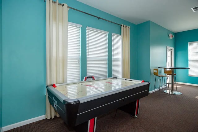 Air hockey table with chairs and table playing area at Mountain Valley Apartments in Morgantown Student Accommodation