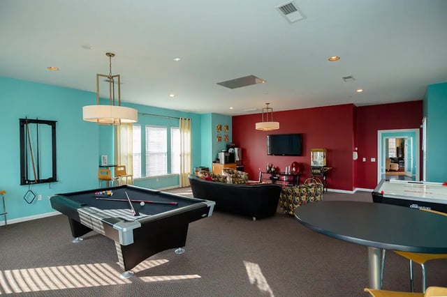 Pool table air hockey table couches living room at Mountain Valley Apartments in Morgantown Student Accommodation