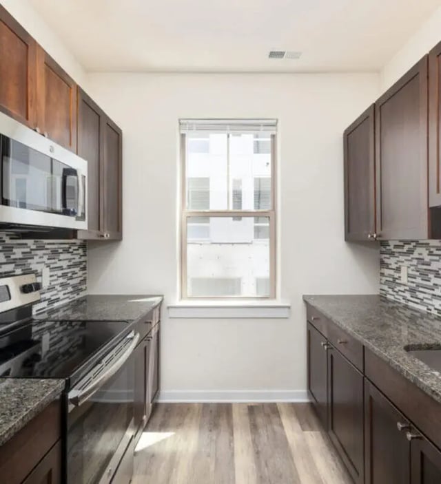 Microwave stove and dark cabinets kitchen at The Eleanor at Chestnut Apartments in Philadelphia Student Accommodation