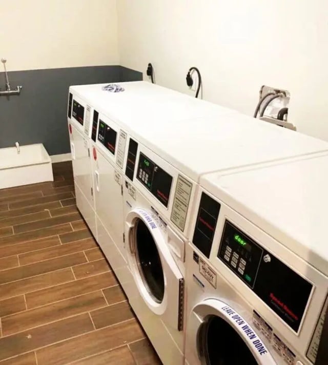 Row of coin operated washers and dryers laundry area at The Eleanor at Chestnut Apartments in Philadelphia Student Accommodation