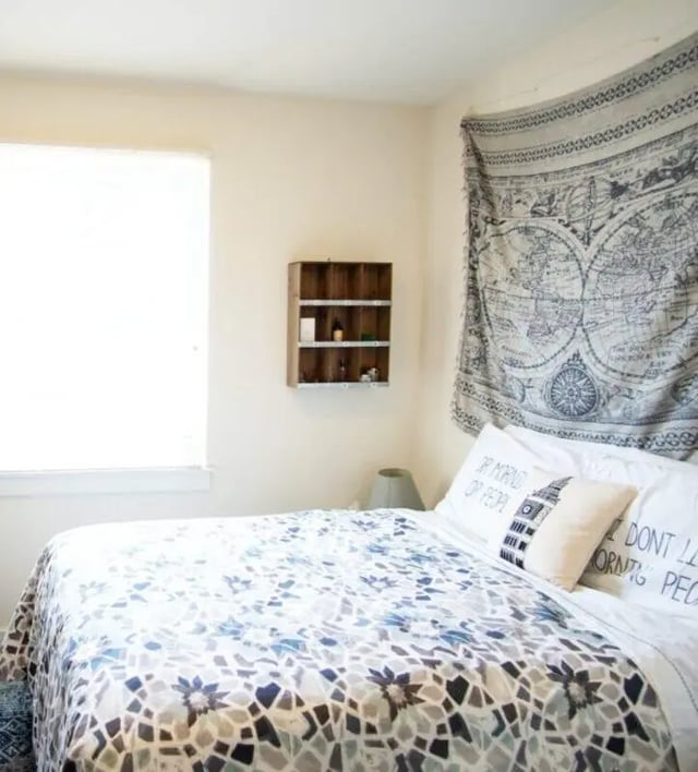 Bed with patterned duvet tapestry and shelf Bedroom at The Eleanor at Chestnut Apartments in Philadelphia Student Accommodation