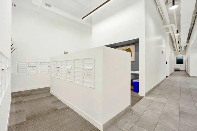 Mailboxes and hallway with artwork Communal area at Post Chicago Apartments in Chicago Student Accommodation