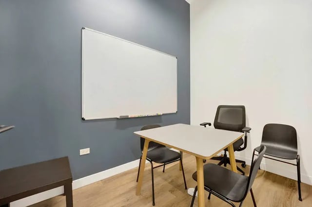 Table chairs and whiteboard study area at Post Chicago Apartments in Chicago Student Accommodation