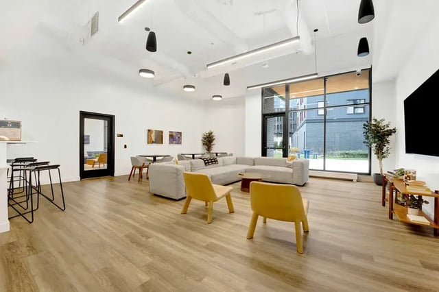 Lounge seating with yellow chairs and a large couch living room at Post Chicago Apartments in Chicago Student Accommodation
