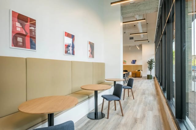 Banquette seating tables chairs artwork common area at Post Chicago Apartments in Chicago Student Accommodation
