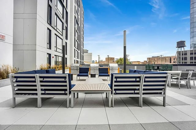 Outdoor lounge seating with grills and tables exterior at Post Chicago Apartments in Chicago Student Accommodation