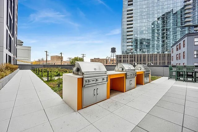 Grills and outdoor seating on rooftop patio area at Post Chicago Apartments in Chicago Student Accommodation
