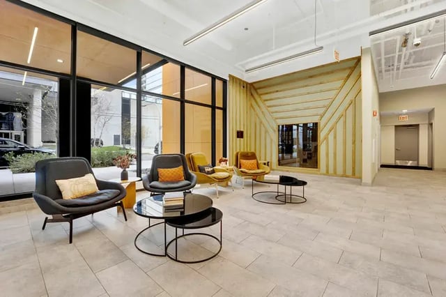 Modern lounge with seating and tables Living area at Post Chicago Apartments in Chicago Student Accommodation