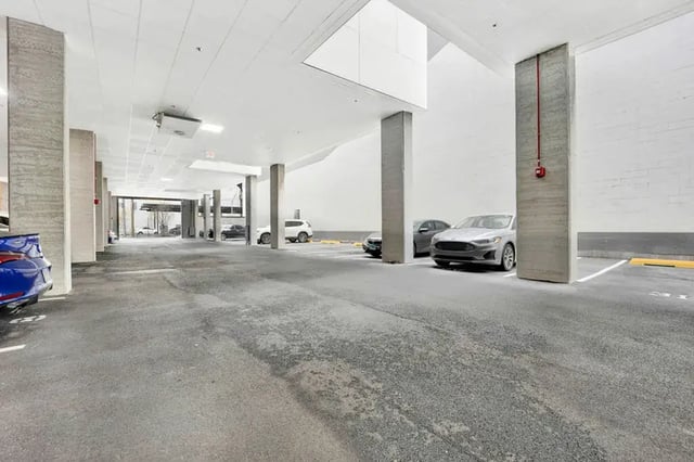 Cars parked in concrete structure interior parking. at Post Chicago Apartments in Chicago Student Accommodation