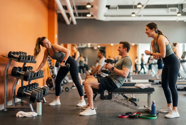 Dumbbells weight bench people exercising gym area at Post Chicago Apartments in Chicago Student Accommodation
