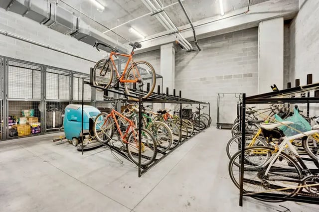 Bicycles and storage cages with cleaning machine Parking area at Post Chicago Apartments in Chicago Student Accommodation