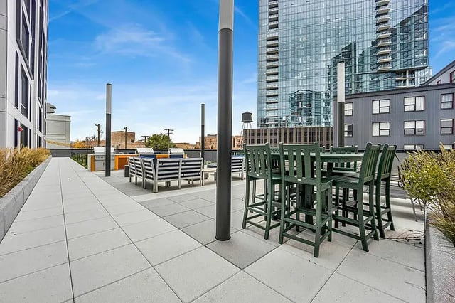 Outdoor seating patio with grills and bar area exterior at Post Chicago Apartments in Chicago Student Accommodation
