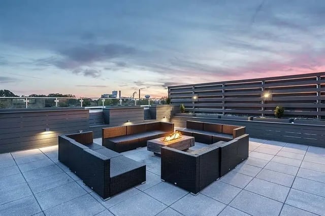Rattan sofas fire pit on patio exterior at Shortbread Lofts in Chapel Hill Student Accommodation