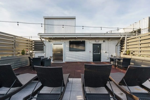 Rooftop lounge chairs tables and building exterior at Shortbread Lofts in Chapel Hill Student Accommodation