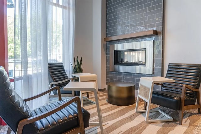 Chairs fireplace and tables common area at Shortbread Lofts in Chapel Hill Student Accommodation