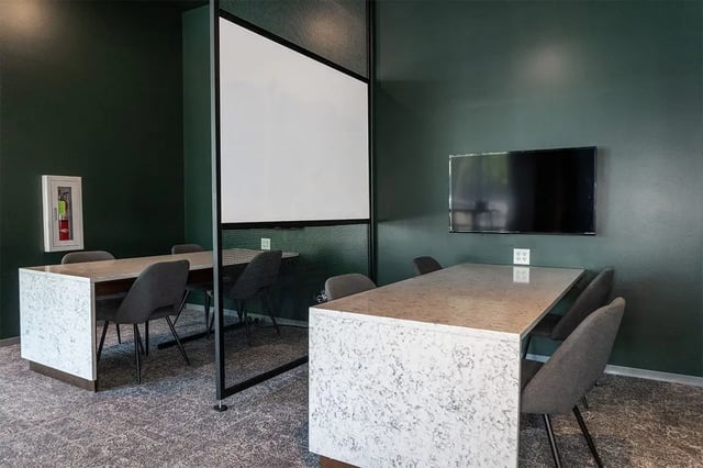Tables and chairs with whiteboard and TV study area at Shortbread Lofts in Chapel Hill Student Accommodation