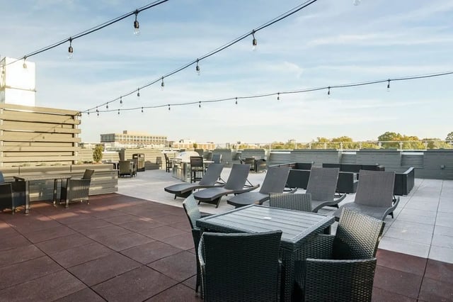 Rooftop lounge chairs tables grill patio exterior at Shortbread Lofts in Chapel Hill Student Accommodation