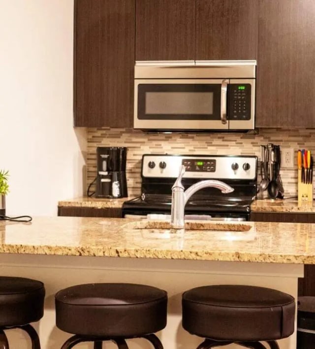 Modern kitchen with granite counter and bar stools kitchen at The Eleanor at Walnut Apartments in Philadelphia Student Accommodation