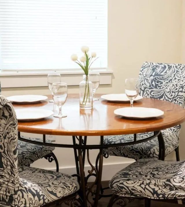 Round dining table with chairs and place settings dining area at The Eleanor at Walnut Apartments in Philadelphia Student Accommodation