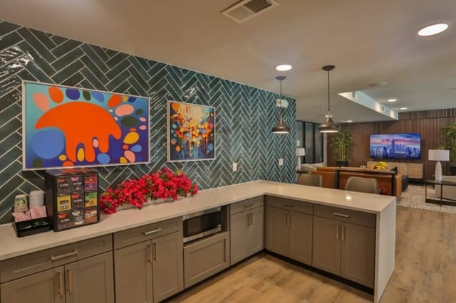 Coffee maker microwave artwork and kitchen counter living room at Maverick Place Apartments in Arlington Student Accommodation