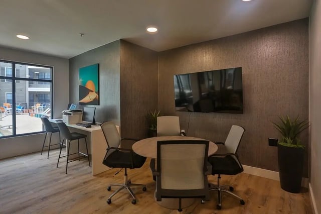 Office area with computers table and chairs living room at Maverick Place Apartments in Arlington Student Accommodation