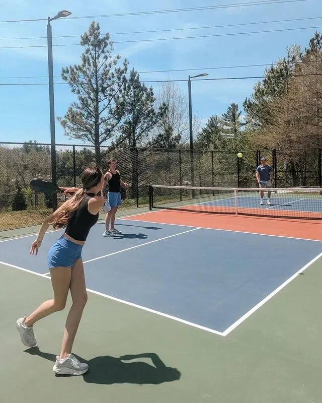 People playing pickleball on outdoor court playing area at Mountaineer Village in Boone Student Accommodation