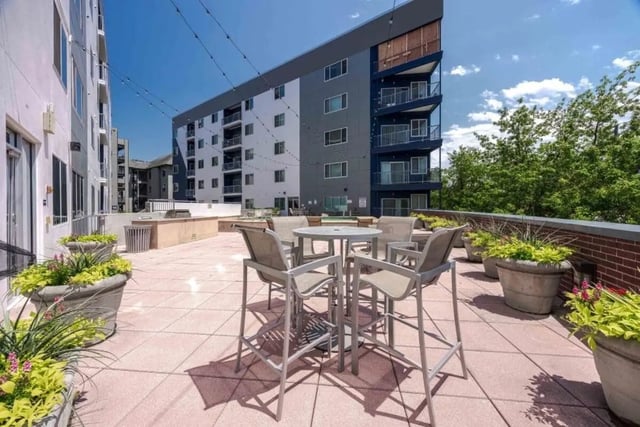 Patio table with chairs and planters exterior at Venue On Guadalupe in Austin Student Accommodation