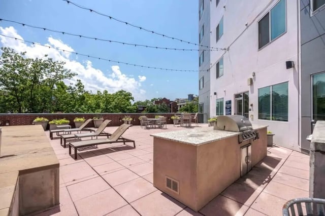 Grill lounge chairs and tables outdoor amenity deck at Venue On Guadalupe in Austin Student Accommodation