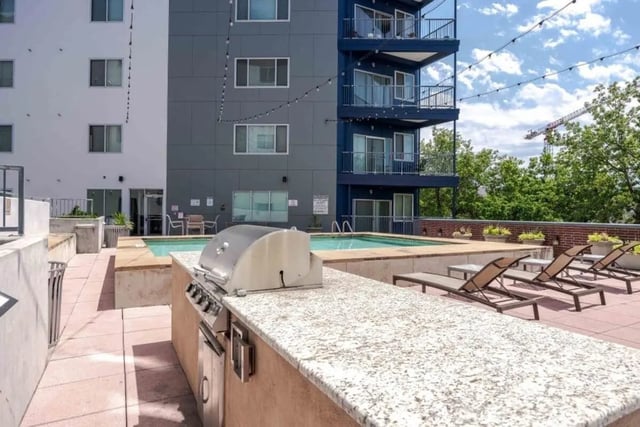 Grill pool lounge chairs patio exterior at Venue On Guadalupe in Austin Student Accommodation
