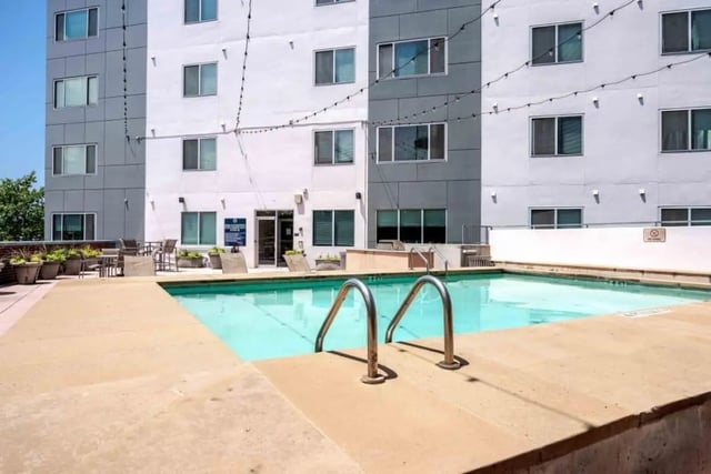 Swimming pool with lounge chairs and tables exterior at Venue On Guadalupe in Austin Student Accommodation