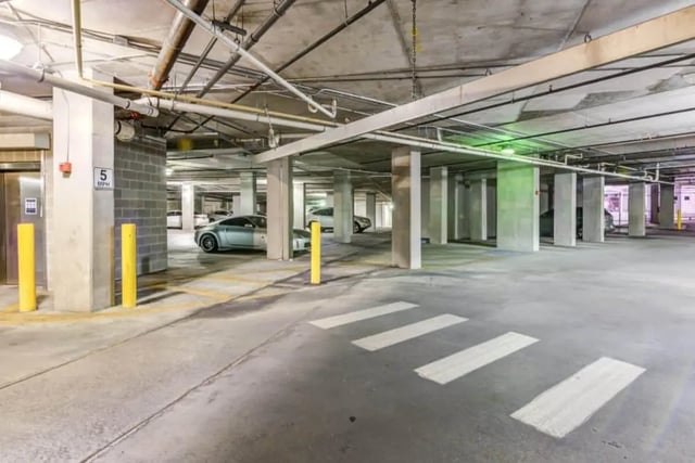 Cars parked in underground parking garage exterior at Venue On Guadalupe in Austin Student Accommodation
