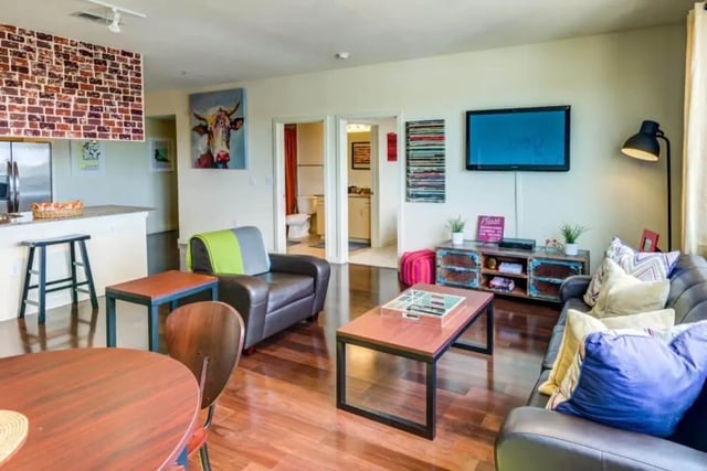 Leather sofa coffee table and kitchen island living room at Venue On Guadalupe in Austin Student Accommodation