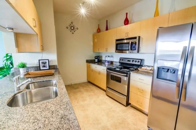 Kitchen with stainless steel appliances and granite countertop kitchen at Venue On Guadalupe in Austin Student Accommodation