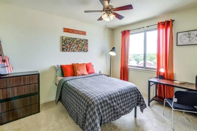 Bed desk guitar dresser with Texas decor bedroom at Venue On Guadalupe in Austin Student Accommodation