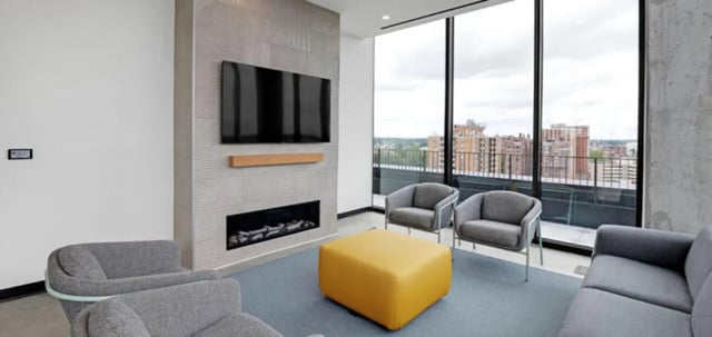 Modern living area with sofa fireplace and chairs living room at Parc View at Commonwealth in Richmond Student Accommodation