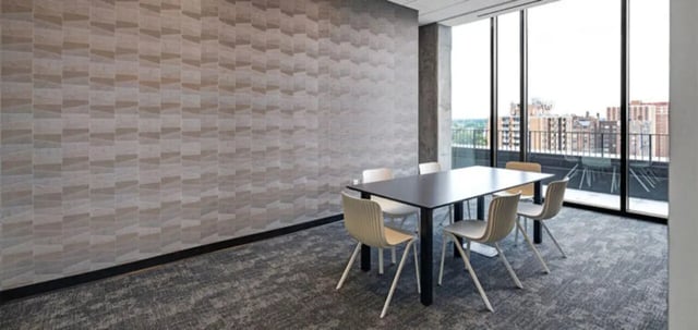 Table and chairs in common room with patterned wall at Parc View at Commonwealth in Richmond Student Accommodation