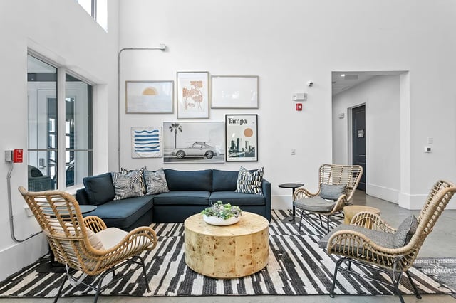 Dark sectional sofa round coffee table living area at Venue at North Campus in Tampa Student Accommodation