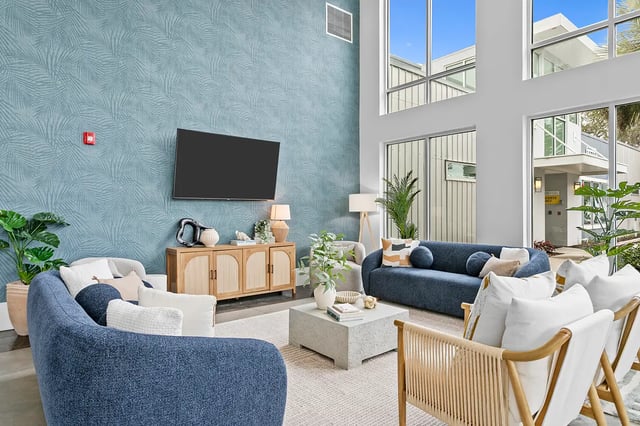 Blue sofas cabinet and tv living room at Venue at North Campus in Tampa Student Accommodation