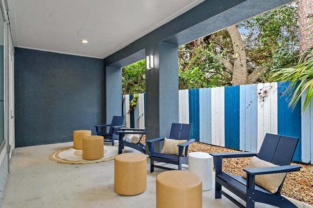 Four chairs and ottomans on patio exterior at Venue at North Campus in Tampa Student Accommodation
