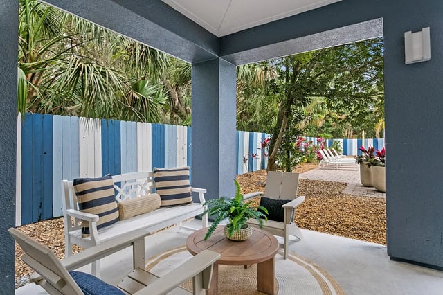 White bench chairs table patio seating exterior at Venue at North Campus in Tampa Student Accommodation