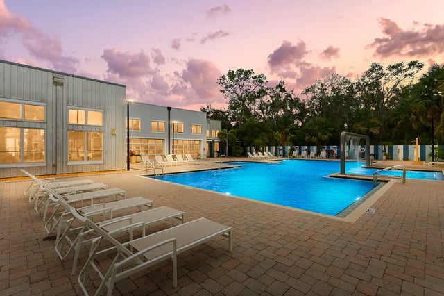 Pool lounge chairs building and water feature exterior at Venue at North Campus in Tampa Student Accommodation