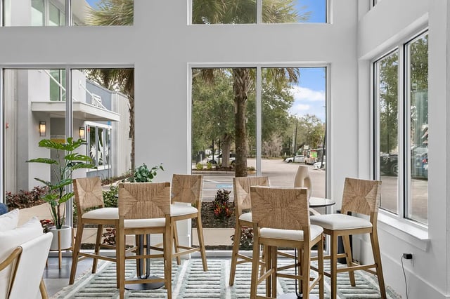 Bar stools and plants in a common area at Venue at North Campus in Tampa Student Accommodation