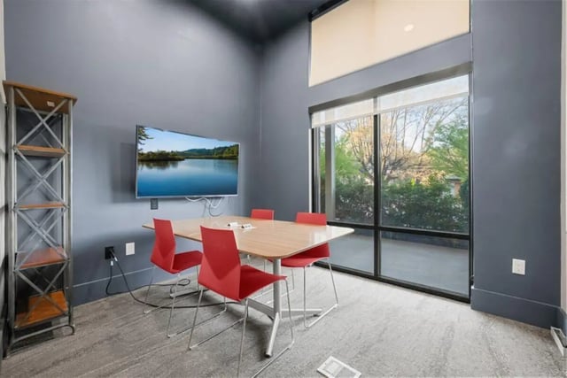 Table with chairs and TV study area at Signature 1505 in Raleigh Student Accommodation