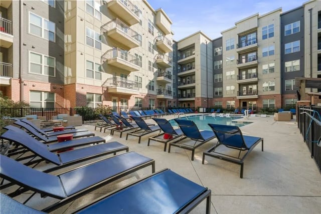 Blue lounge chairs by pool exterior at Signature 1505 in Raleigh Student Accommodation