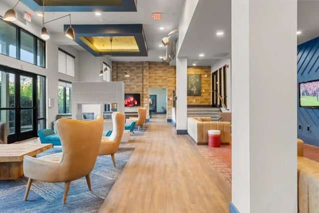 Modern lounge with chairs sofa and TV at Signature 1505 in Raleigh Student Accommodation