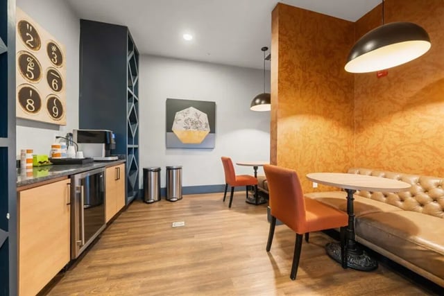 Coffee maker chairs table couch lounge area at Signature 1505 in Raleigh Student Accommodation