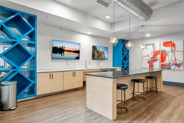 Island kitchen with bar stools and artwork kitchen at Signature 1505 in Raleigh Student Accommodation