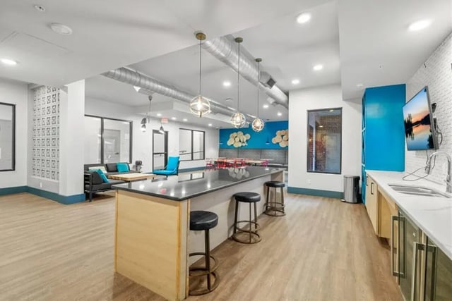 Island kitchen bar seating lounge area living room. at Signature 1505 in Raleigh Student Accommodation